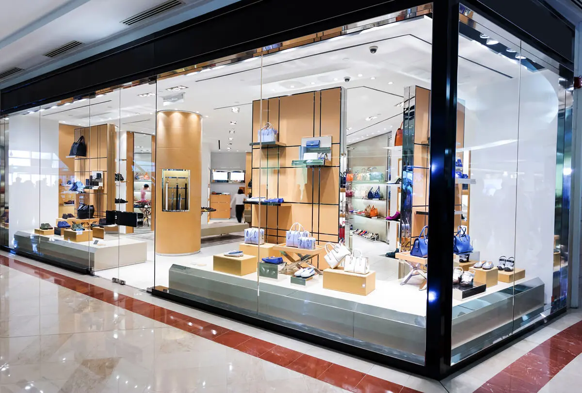 Luxury store with handbags and accessories display.
