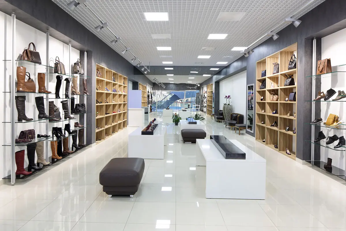 Shoe store with shelves and seating area.