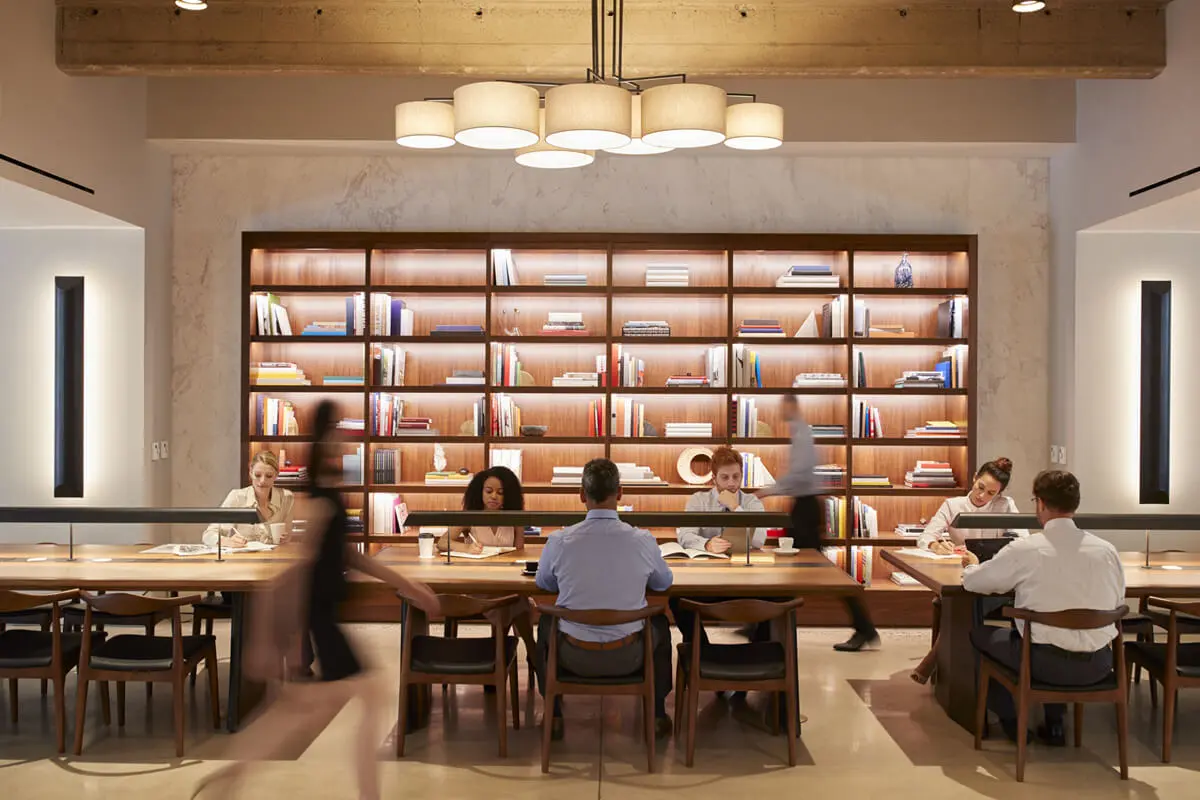 People working in a modern library space.